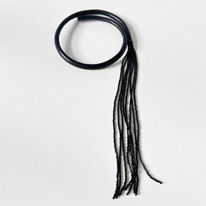 Black leather choker with black beaded tassel, showcasing a versatile design that can be worn in multiple ways.