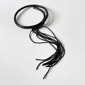 Black leather choker with black beaded tassel, showcasing a versatile design that can be worn in multiple ways.