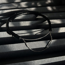 Load image into Gallery viewer, Close-up of a handcrafted leather choker featuring smooth black leather and delicate silver Japanese glass beads, creating a bold yet elegant minimalist design