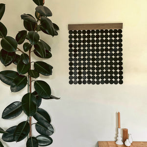 A wall hanging decor made with deep green leather, supple suede, and stained poplar wood. Ethically crafted and inherently stylish, it adds a luxurious touch to your space, creating captivating visual harmony. Its lightweight design ensures easy mounting, allowing you to curate a personalized aesthetic with ease.