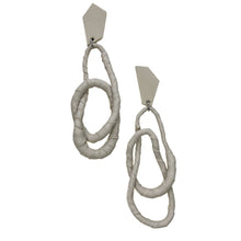 Load image into Gallery viewer, Image of a pair of Ivory Geo Flex Earrings, featuring asymmetric geometric studs wrapped in luxurious off-white leather.