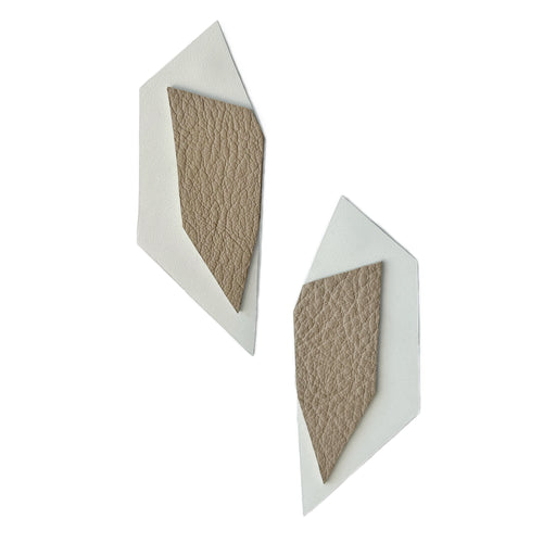 Handcrafted leather earrings featuring oversized geometric sharp shapes in beige over white. The confident, stylish design and dramatic oversized flair complement any outfit with a sleek and contemporary aesthetic.