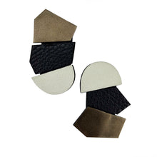 Load image into Gallery viewer, Oversized unique leather earrings with asymmetrical shapes, combining ivory, black, and metallic copper leathers. Designed for the modern trendsetter, these lightweight earrings merge contemporary style with artistic expression, perfect for making a bold fashion statement.