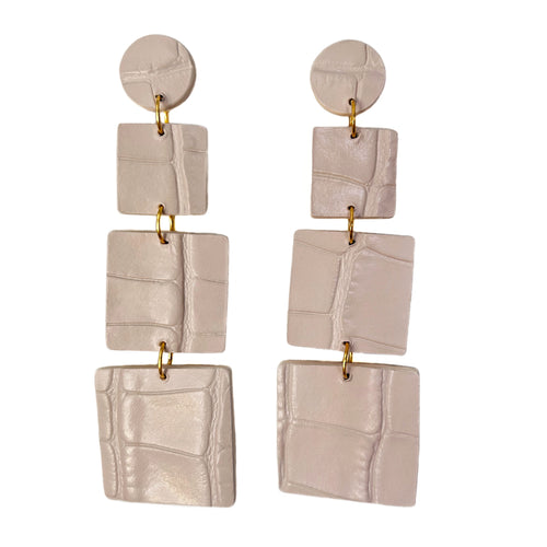 Handmade ivory alligator leather earrings featuring three tiered squares of varying sizes, elegantly dangling to provide a sophisticated yet lightweight accessory suitable for all-day wear.