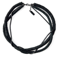 Load image into Gallery viewer, Three-layer elegant leather necklace featuring one strand of gleaming hematite beads and two strands of hand-cut black leather beads in varying sizes, emphasizing a sophisticated and mysterious appearance.