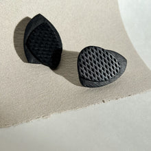 Load image into Gallery viewer, Striking black leather earrings with unique organic shapes, handcrafted from premium upcycled leather. Each pair combines smooth and textured surfaces for a visually contrasting design, ideal for adding a chic, eco-conscious touch to any outfit.