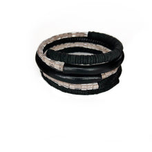 Load image into Gallery viewer, Black leather coil bracelet made from punched disks and stitched leather tube, with blush pink shiny glass beads