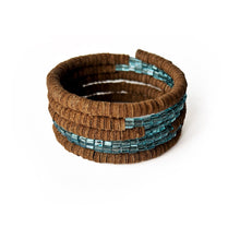 Load image into Gallery viewer, Wrap-around bracelet featuring earthy suede leather and shimmering blue Japanese beads in a layered design, showcasing a blend of texture and elegance. Lightweight and adjustable for a comfortable fit.