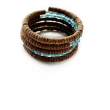 Load image into Gallery viewer, Wrap-around bracelet featuring earthy suede leather and shimmering Japanese beads in a layered design, showcasing a blend of texture and elegance. Lightweight and adjustable for a comfortable fit.