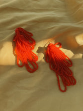 Load image into Gallery viewer, Cascading red beaded earrings with hand‑stitched strands on a leather base, handmade by WAIWAI.