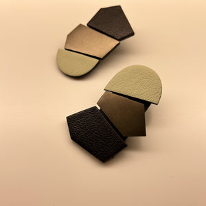 Oversized unique leather earrings with asymmetrical shapes, combining ivory, black, and metallic copper leathers. Designed for the modern trendsetter, these lightweight earrings merge contemporary style with artistic expression, perfect for making a bold fashion statement.