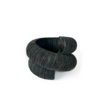 Load image into Gallery viewer, Handcrafted bracelet made from upcycled leather in a rich green tone, featuring a sculptural and layered design with a unique spiral form.