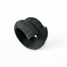 Load image into Gallery viewer, Handcrafted bracelet made from upcycled leather in a rich brown tone, featuring a sculptural and layered design with a unique spiral form.