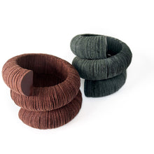 Load image into Gallery viewer, Handcrafted bracelet made from upcycled leather in a rich brown tone, featuring a sculptural and layered design with a unique spiral form.