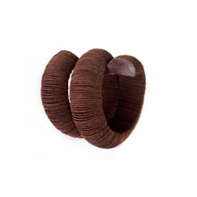 Load image into Gallery viewer, Handcrafted bracelet made from upcycled leather in a rich brown tone, featuring a sculptural and layered design with a unique spiral form.