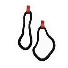 Load image into Gallery viewer, A pair of reshapable earrings handcrafted from black leather with a textured finish, forming irregular looped shapes, accented by bold red leather connectors. Lightweight and versatile for unique styling.