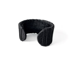 Load image into Gallery viewer, A handcrafted black leather cuff bracelet featuring a ridged texture and a minimal design