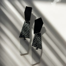 Load image into Gallery viewer, Sleek, asymmetrical leather earrings featuring three geometric shapes in crisp white, bold black, and a striking black-and-white pattern. Perfect for adding a contemporary and dynamic touch to any ensemble, crafted for those who appreciate clean lines and modern design.