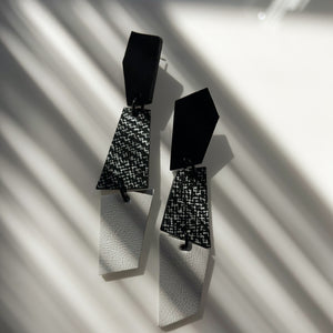 Sleek, asymmetrical leather earrings featuring three geometric shapes in crisp white, bold black, and a striking black-and-white pattern. Perfect for adding a contemporary and dynamic touch to any ensemble, crafted for those who appreciate clean lines and modern design.