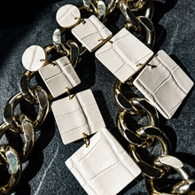 Load image into Gallery viewer, Handmade ivory alligator leather earrings featuring three tiered squares of varying sizes, elegantly dangling to provide a sophisticated yet lightweight accessory suitable for all-day wear.