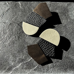 Oversized unique leather earrings with asymmetrical shapes, combining ivory, black, and metallic copper leathers. Designed for the modern trendsetter, these lightweight earrings merge contemporary style with artistic expression, perfect for making a bold fashion statement.