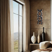 Load image into Gallery viewer, Handcrafted wall art made from upcycled leather, featuring a snakeskin-inspired design with individually hand-punched scales in earthy tones, perfect for adding texture and sustainability to modern interiors.