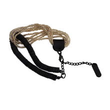 Load image into Gallery viewer, Handcrafted bracelet with golden glass beads interlocked with black leather disks and adjustable chain.