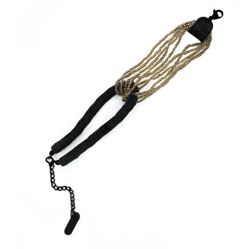 Handcrafted bracelet with golden glass beads interlocked with black leather disks and adjustable chain.