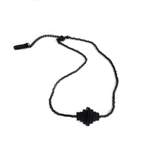 Load image into Gallery viewer, Black sculptural necklace with stacked hand-punched leather discs and black Japanese glass bead strand.