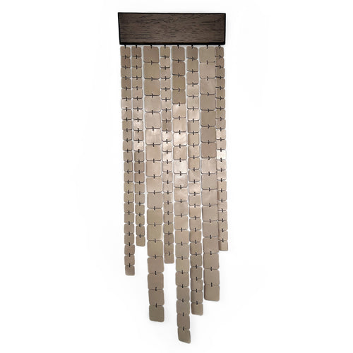 Minimalist wall hanging made of leather and wood, handcrafted and suspended, with freely hanging glossy leather strips catching light.

