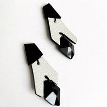 Load image into Gallery viewer, Black and white geometric drop earrings made from layered upcycled leather with faceted black Swarovski crystal bead