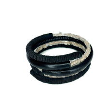 Load image into Gallery viewer, Black leather coil bracelet made from punched disks and stitched leather tube, with blush pink shiny glass beads


