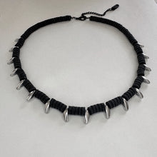 Load image into Gallery viewer, Black necklace with silver spike-like ends on a white background