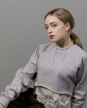 Load image into Gallery viewer, Woman wearing a gray sweatshirt with lace trim and leather choker with chains and rose quartz stones against a plain background