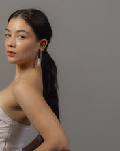 Load image into Gallery viewer, Model wearing long leather earrings with rose quartz drops