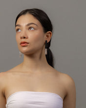 Load image into Gallery viewer, Model wearing long leather earrings with rose quartz drops