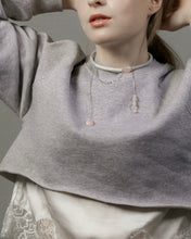 Load image into Gallery viewer, Person wearing a gray sweater with a necklace featuring pink stones against a neutral background
