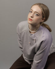 Load image into Gallery viewer, Woman wearing a gray sweatshirt with lace trim and leather choker with chains and rose quartz stones against a plain background