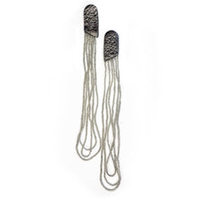 Load image into Gallery viewer, Long sculptural earrings handcrafted from reclaimed leather with strands of transparent silver-lined Japanese glass beads and stainless steel posts.