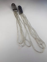 Load image into Gallery viewer, Long sculptural earrings handcrafted from reclaimed leather with strands of transparent silver-lined Japanese glass beads and stainless steel posts.