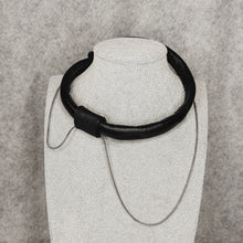 Load image into Gallery viewer, A close-up of an elegant leather choker featuring hand-stitched genuine leather and a high-quality stainless steel chain. The choker is adorned with a removable leather bead and is displayed against a neutral background.