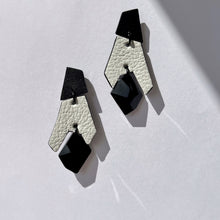 Load image into Gallery viewer, Black and white geometric drop earrings made from layered upcycled leather with faceted black Swarovski crystal bead