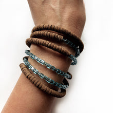 Load image into Gallery viewer, Wrap-around bracelet featuring earthy suede leather and shimmering Japanese beads in a layered design, showcasing a blend of texture and elegance. Lightweight and adjustable for a comfortable fit.