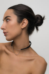 Close-up of a handcrafted leather choker featuring smooth black leather and delicate silver Japanese glass beads, creating a bold yet elegant minimalist design