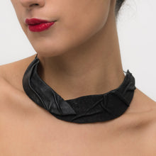 Load image into Gallery viewer, Close-up of a handcrafted leather necklace with two distinct textures, featuring an inner wire that allows for reshaping. The adjustable design offers a personalized touch, blending contrast and harmony in a bold, simple statement piece.