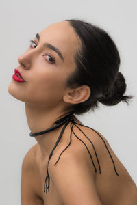 Black leather choker with black beaded tassel, showcasing a versatile design that can be worn in multiple ways.