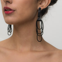 Load image into Gallery viewer, Pair of Noir Cascade earrings featuring black Japanese glass beads cascading in layered strands, combined with soft black leather accents for a bold and elegant look.