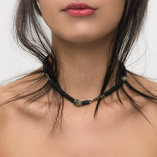 Load image into Gallery viewer, Handcrafted necklace featuring black leather discs, labradorite stones with iridescent sheen, and metallic pyrite gemstones, designed with a bold and modern aesthetic.