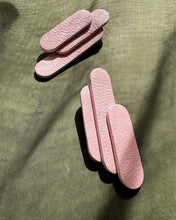 Load image into Gallery viewer, Layered pink leather earrings with rounded geometric shapes on green background