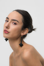 Load image into Gallery viewer, A pair of handcrafted earrings made from upcycled black leather, featuring a sculptural, layered design resembling a spinning top or central axis.